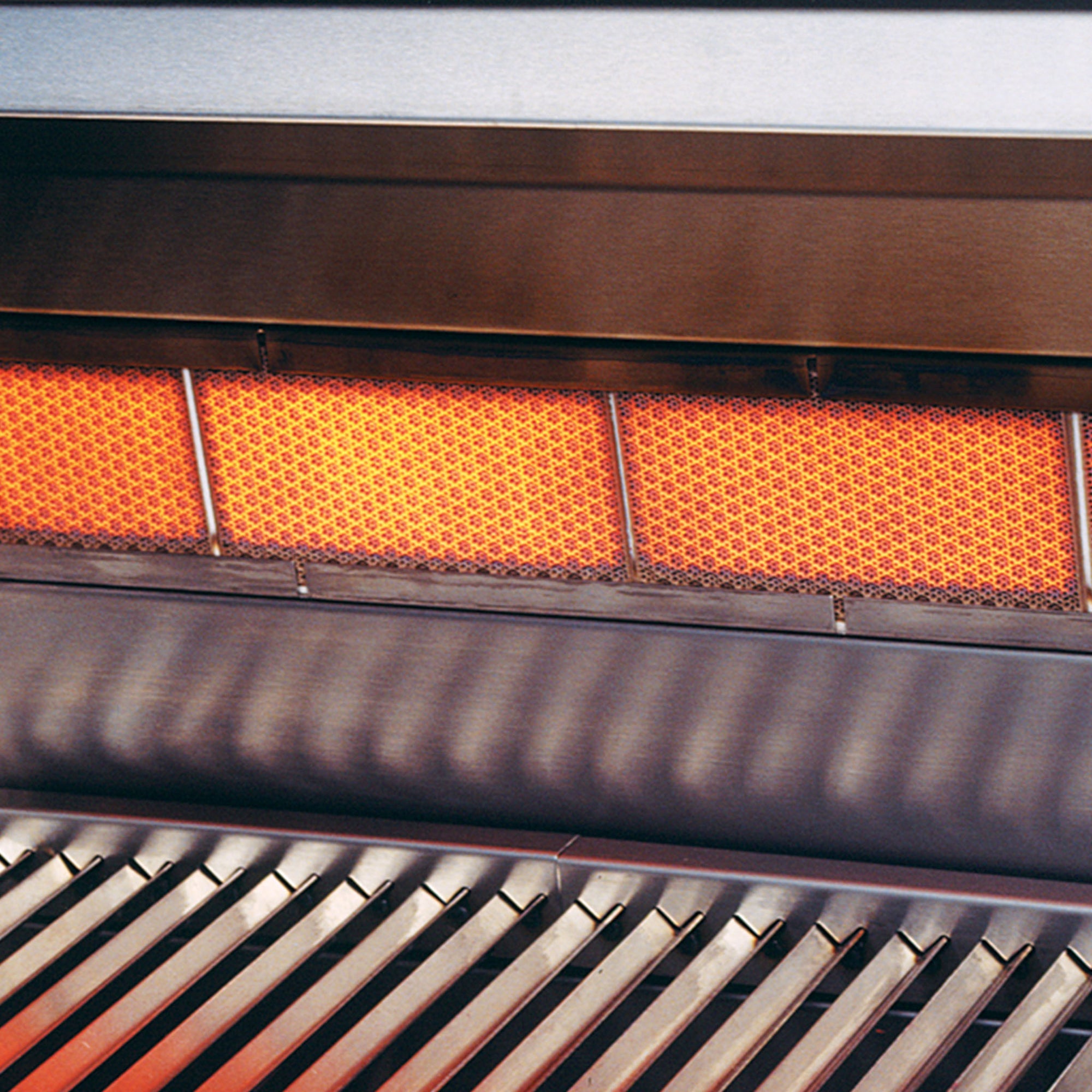 Close-up of a grill with glowing orange heating elements